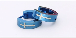 Macro detail of blue stainless steel hoop earrings featuring silver cross pattern design