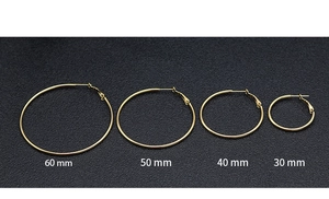 Detail showing four sizes of gold hoop earrings in 30mm, 40mm, 50mm, and 60mm diameters
