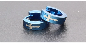 Macro detail of blue electroplated stainless steel earrings with metallic cross pattern