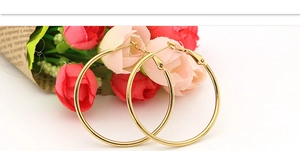 Polished gold hoop earrings for women presented with a romantic rose bouquet background