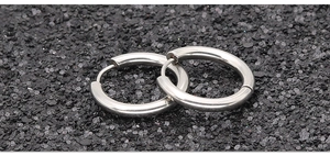 Macro shot of silver stainless steel hoop earrings with high mirror-polished finish