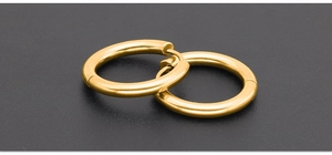 Detailed view of polished chunky golden hoop earrings in 316L stainless steel