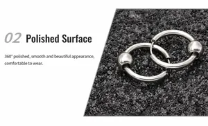 Macro view of mirror polished stainless steel hoop earring with a single metal bead