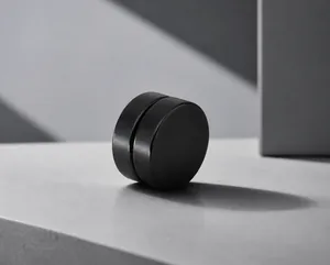 Detail of matte black magnetic stud earring for non-pierced ears in a minimalist design
