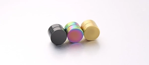 Three pairs of magnetic stud earrings in black, rainbow, and gold on white background