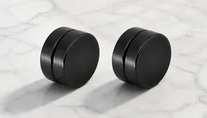 Detail of black magnetic stud earrings for men with a matte brushed titanium steel texture
