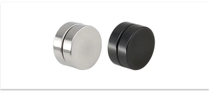 Detail view of silver and matte black magnetic stud earrings in durable titanium steel