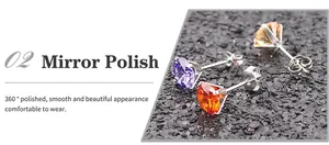 Detailed macro view of 360-degree polished titanium earrings with AAA colored zircon studs