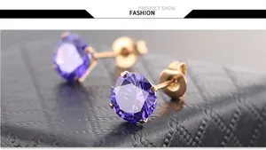 Macro shot of purple cubic zirconia stud earrings with classic four-prong gold setting
