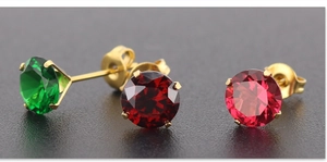 Detail view of round cubic zirconia earrings in gold four-claw setting with varied colors