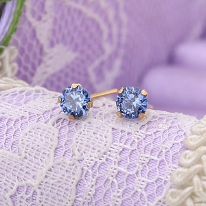 Titanium steel stud earrings with 4mm blue crystal stones in a golden 4-prong setting
