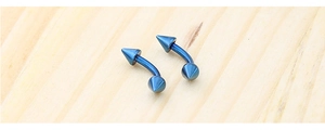 Macro detail of blue titanium steel curved barbell piercing with sharp cone ends