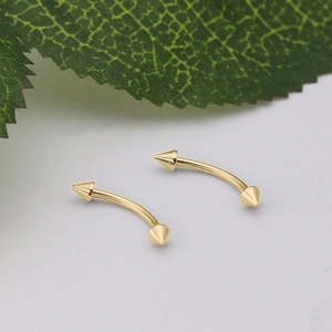 Pair of gold curved barbell eyebrow rings with spikes in 316 stainless steel finish