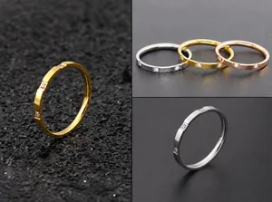Detailed view of slim titanium steel rings with square zircon stones in gold, silver, rose gold
