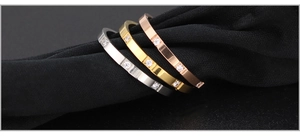 Detailed close-up of three polished titanium steel rings with cubic zirconia stones