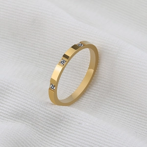 Modern gold titanium steel ring with geometric stepped facets and three inlaid zircons