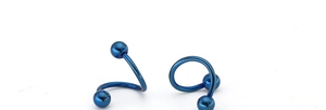 Detail view of blue titanium steel spiral body piercing rings with polished ball ends