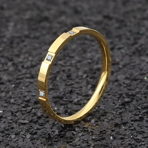 Elegant gold titanium steel ring featuring three sparkling cubic zirconia stones
