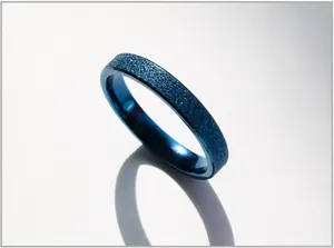 Detailed close-up of blue frosted matte stainless steel ring with subtle glitter finish