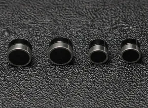 Detailed view of black round magnetic clip-on earrings in large and small sizes
