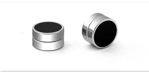 Close-up of magnetic titanium steel ear clips with black round epoxy inlay and silver base