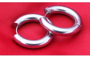 Macro shot of thick silver stainless steel hoop earrings with secure pin closures