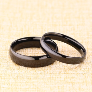Polished black titanium steel domed couple rings with minimalist mirror finish design