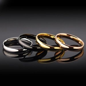 Set of four minimalist titanium steel rings in silver, black, gold and rose gold colors