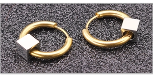 Detailed close-up of two-tone stainless steel hoop earrings with silver square beads