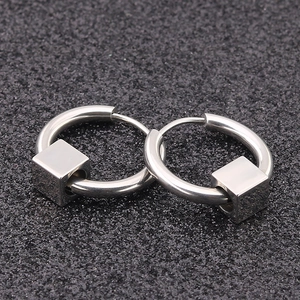 Polished titanium steel hoop earrings with square bead charms on a dark textured background