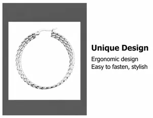 Macro view of oversized silver twist rope hoop earring with textured metal surface detail