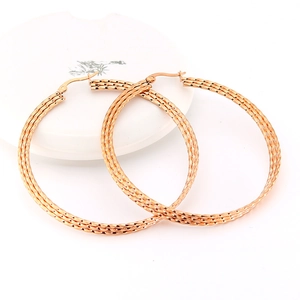Polished rose gold hoop earrings with woven texture and a classic clasp closure