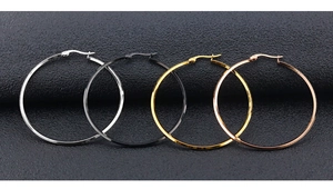 Detailed close-up of classic hoop earrings set in silver, black, gold and rose gold finishes