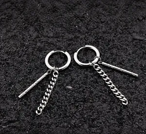 Detailed macro view of silver stainless steel chain drop earrings on black stone