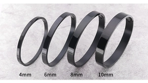 Detail view of 4mm to 10mm wide black stainless steel bangles with polished finish