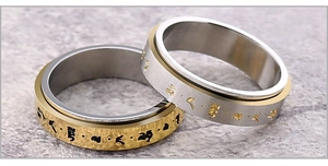 Macro de anillos giratorios en oro y plata con mantra grabado en acero inoxidable