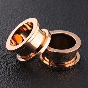 Pair of rose gold stainless steel hollow ear gauges with a polished mirror finish for body piercing