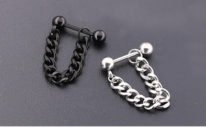 Detail of punk style stainless steel stud earrings with silver and black ball chains