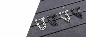 Detailed macro view of punk style titanium steel ball chain earrings in silver and black