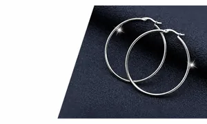Polished silver titanium steel hoop earrings with secure latch closure shown on blue background