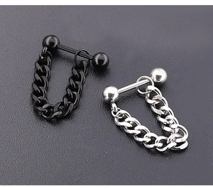 Detail of industrial punk barbell stud earrings with heavy Cuban chain in black and silver