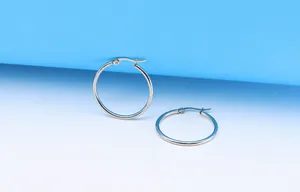 Detailed view of polished stainless steel hoop earrings with secure clasp design