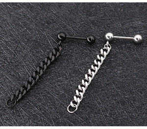 Detail of punk style ball stud earrings with hanging curb chain in black and silver steel