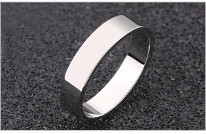Macro shot of polished stainless steel flat band ring with smooth mirror finish surface