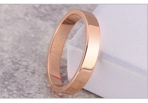 Macro close-up of rose gold flat band ring with a high-polished mirror finish