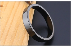 Polished black titanium steel flat ring shown on a textured wooden stand detail