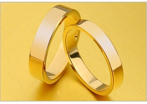 Macro view of two polished gold stainless steel rings with a smooth mirror finish