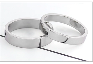 Macro shot of two polished silver stainless steel flat rings with mirror finish surface