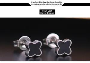 Macro shot of clover-shaped titanium steel stud earrings with black enamel inlay