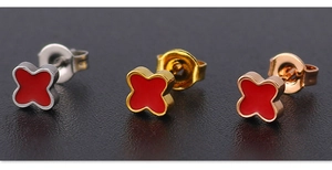 Detailed macro view of four-leaf clover stud earrings in silver, gold, and rose gold plating